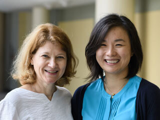 Senior scientist and junior scientist smiling